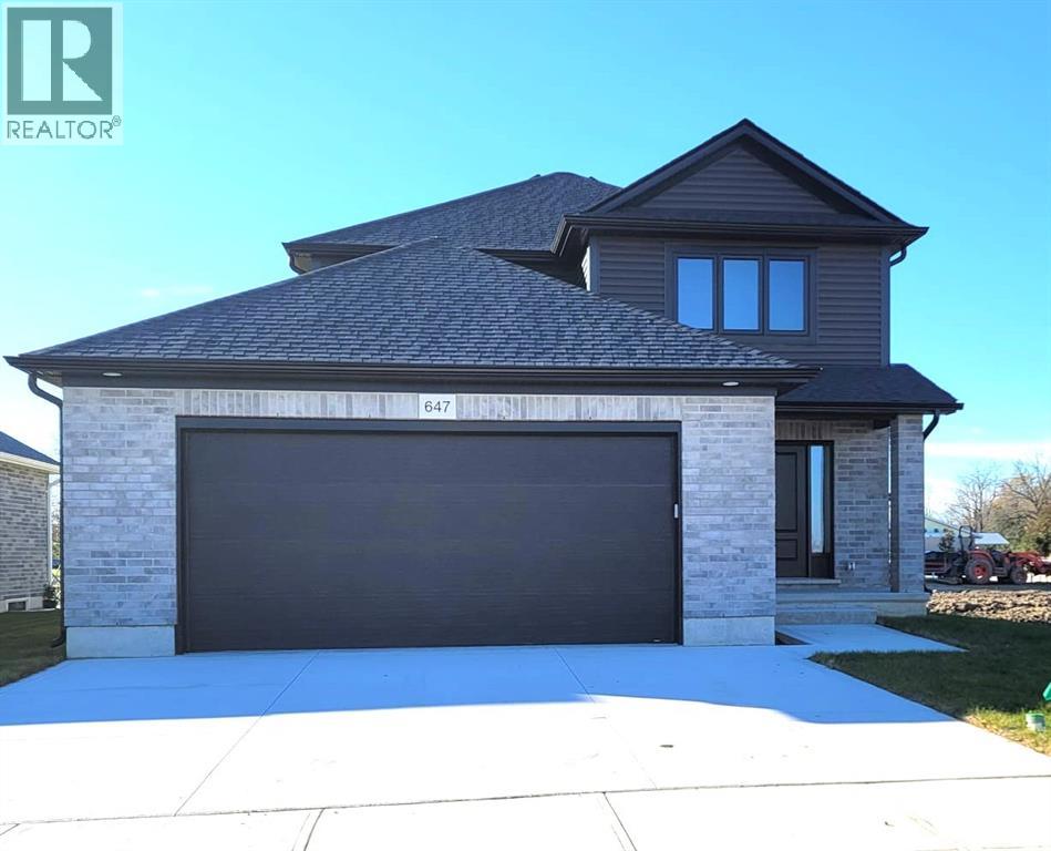 A house with a garage door numbered 647 is for sale.