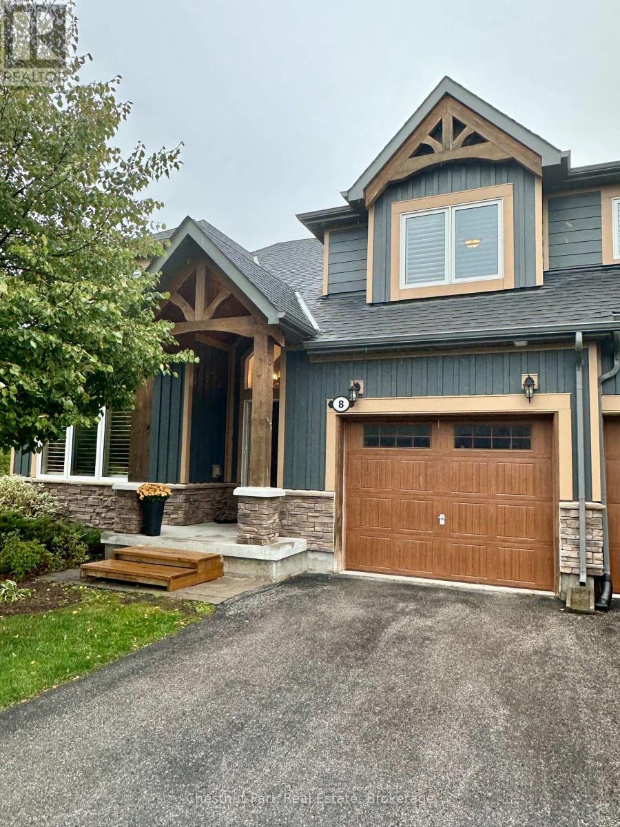 A house with a brown garage door and a stone pillar.