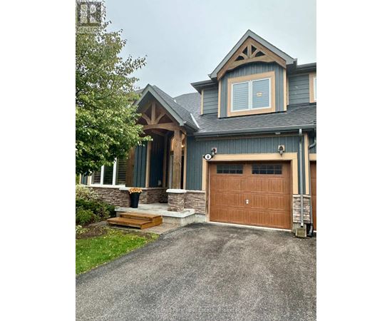 A house with a brown garage door and a stone pillar.