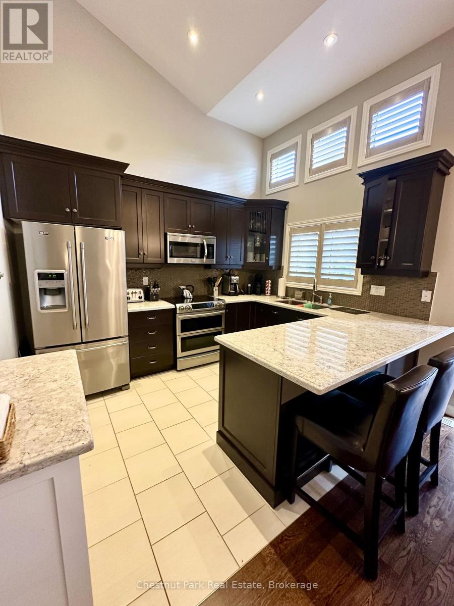 A kitchen with a table and chairs.
