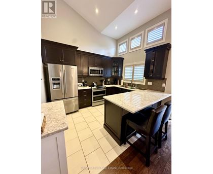 A kitchen with a table and chairs.