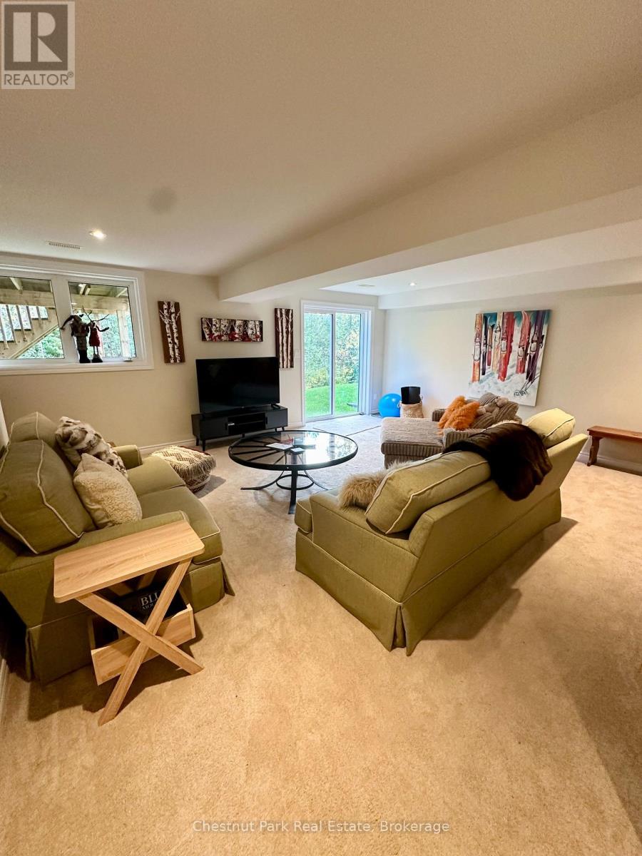 A living room with a green couch and a wooden table.