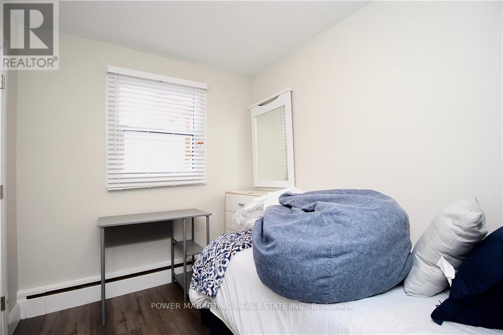 A bedroom with a round bed and a mirror on the wall.