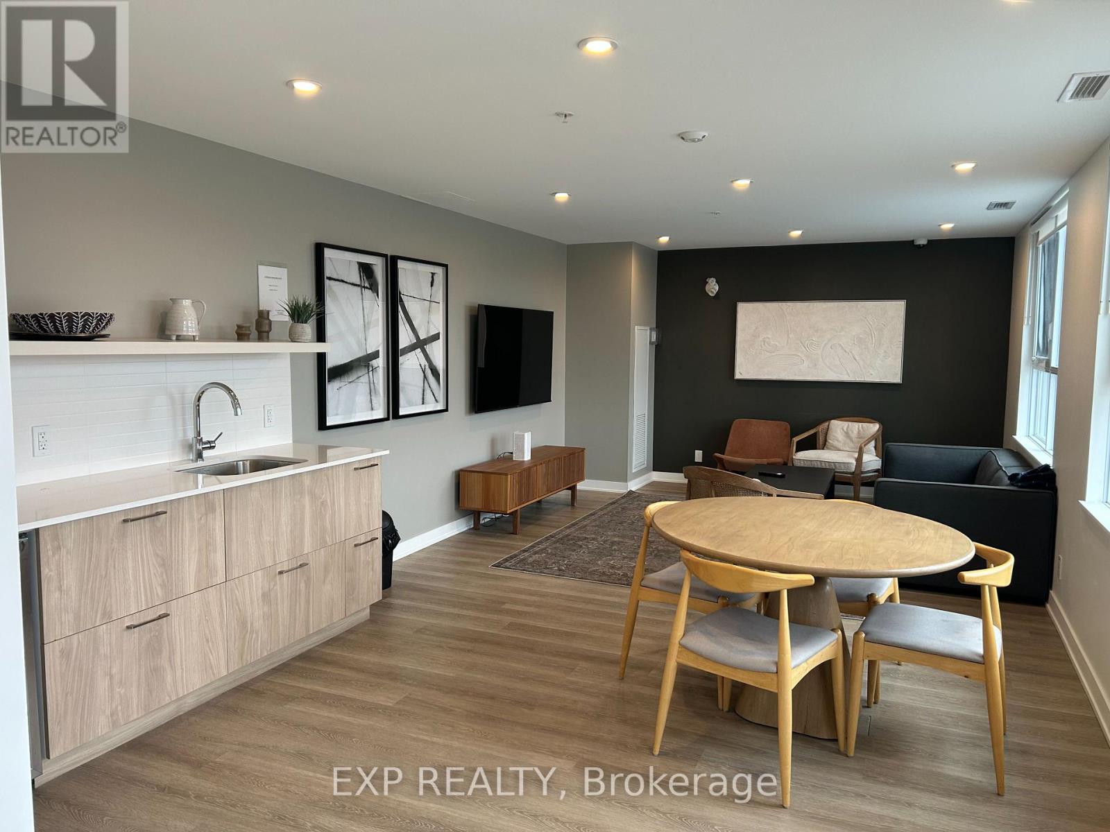 A modern kitchen with wooden floors and furniture.