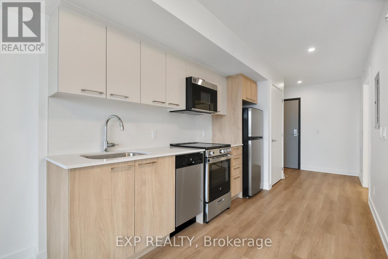 A kitchen with wooden cabinets and stainless steel appliances is on the market.
