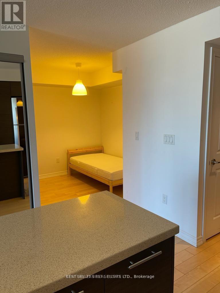 A bedroom with a bed and a dresser in it.