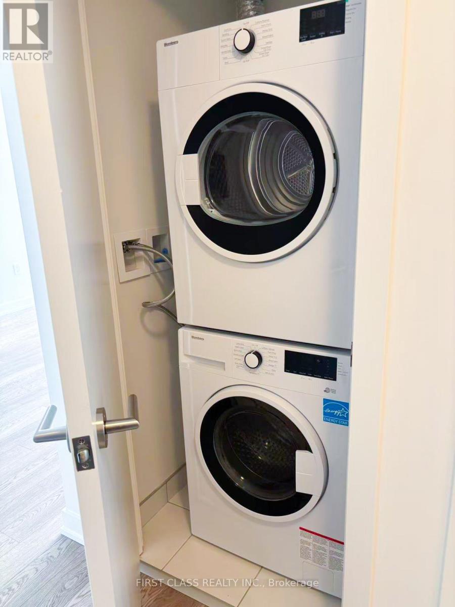 A washer and dryer combo is installed in a wall.