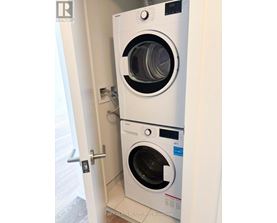 A washer and dryer combo is installed in a wall.
