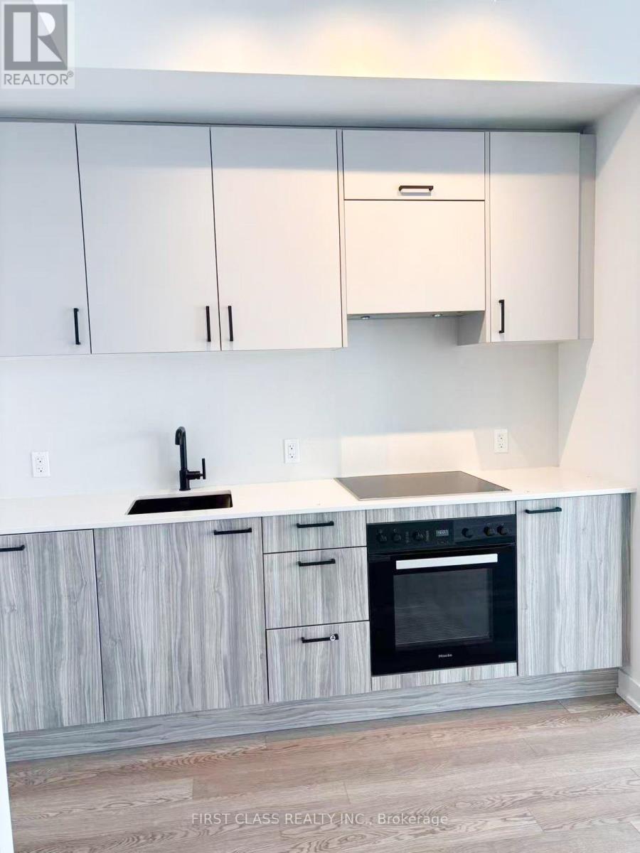 A kitchen with white cabinets and a wooden counter.