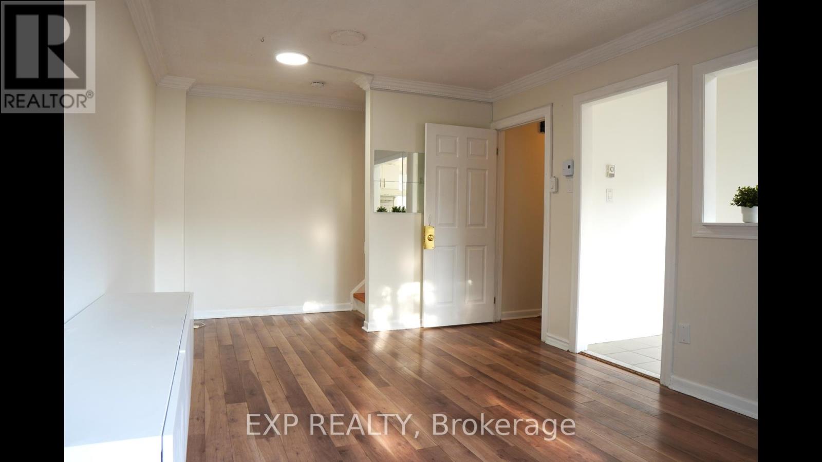 A room with wooden floors and white walls.