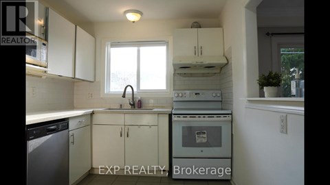 A kitchen with white cabinets and a dishwasher.