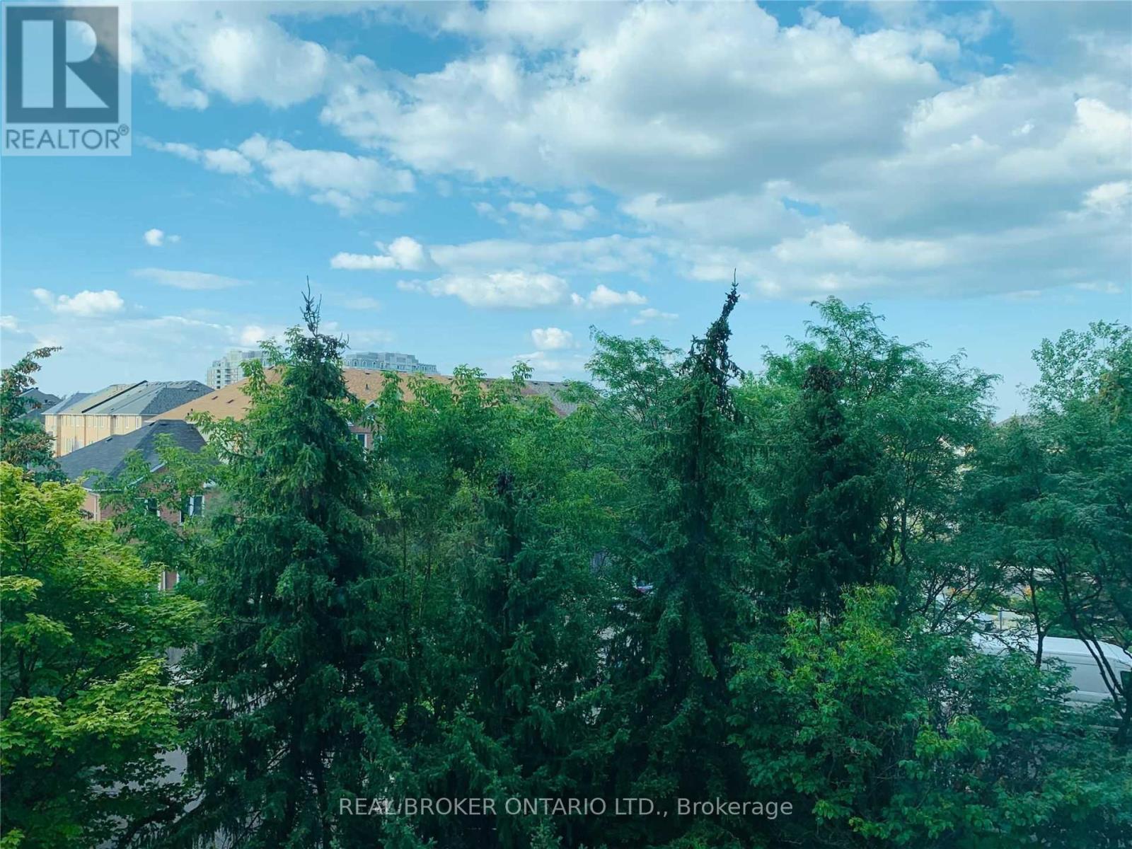 A lush green landscape with trees and a clear sky.