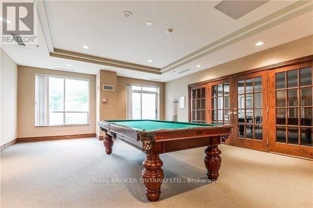 A pool table in a room with a window and a door.