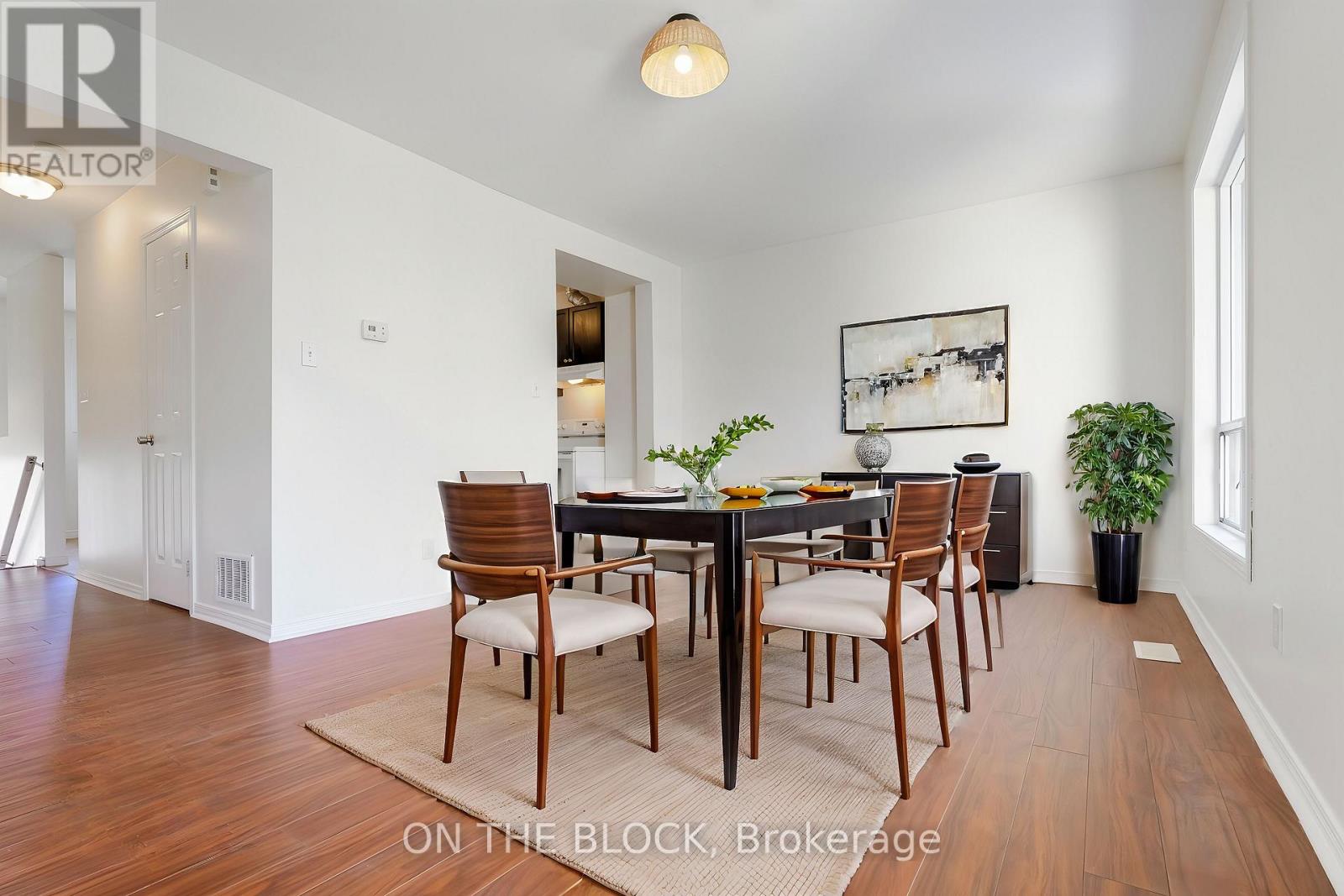 A dining room with a table set for six.