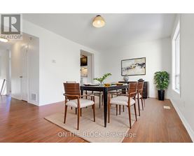 A dining room with a table set for six.