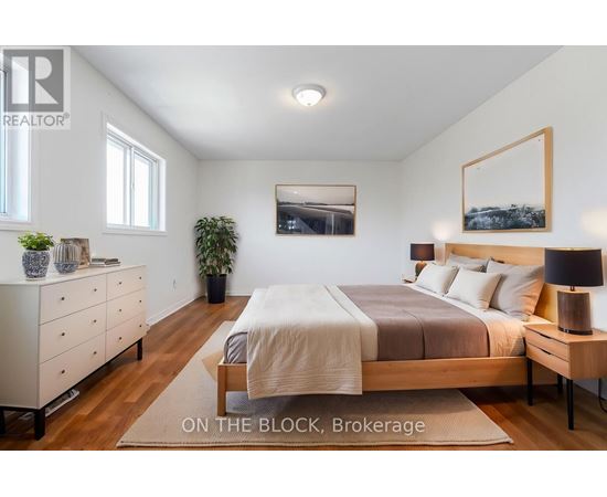 A bedroom with a bed, nightstand, and dresser.