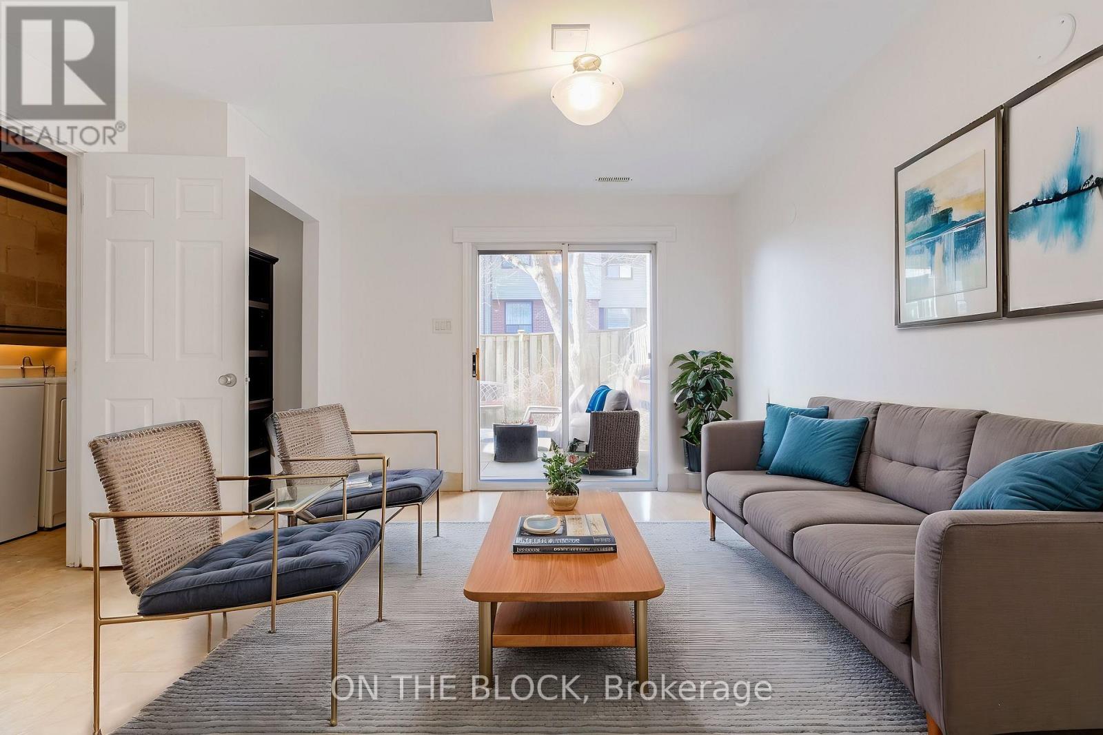 A living room with a couch, chairs, and a coffee table.