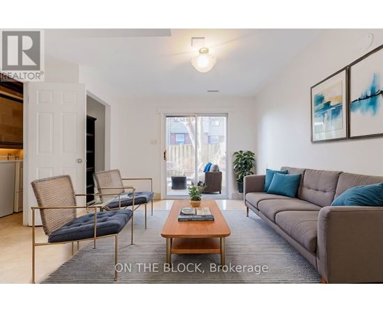 A living room with a couch, chairs, and a coffee table.