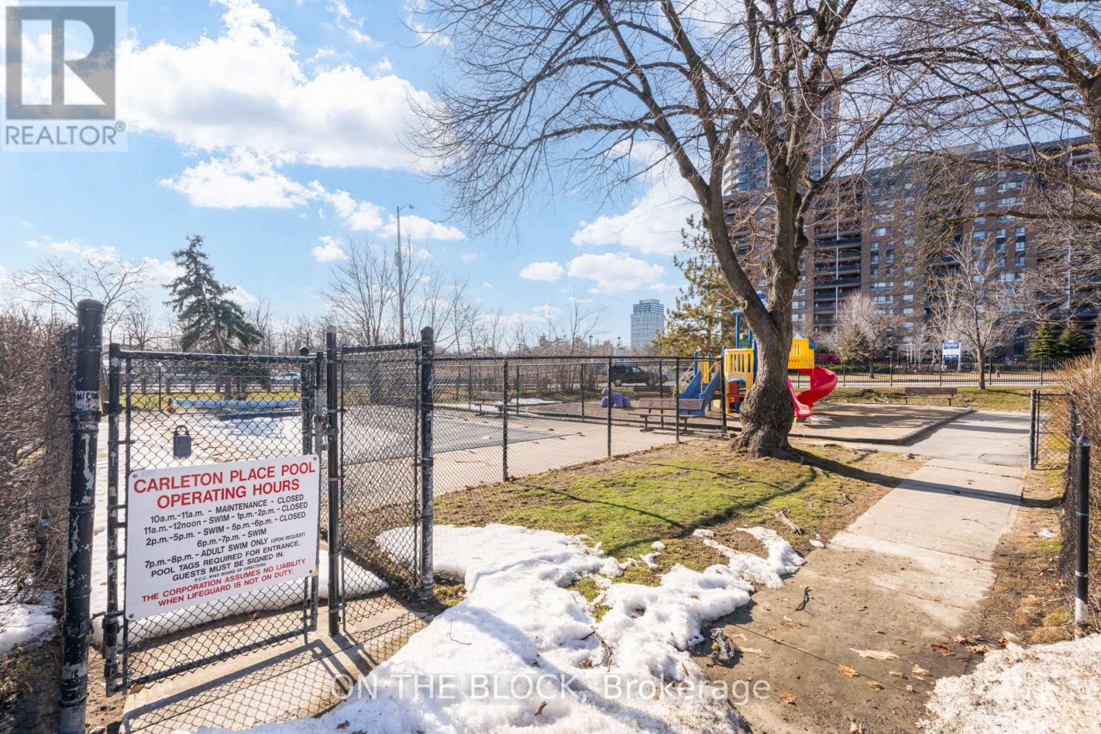 A sign at the entrance of a fenced area reads "Carleton Place Pool Operating Hours".