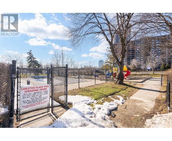 A sign at the entrance of a fenced area reads "Carleton Place Pool Operating Hours".