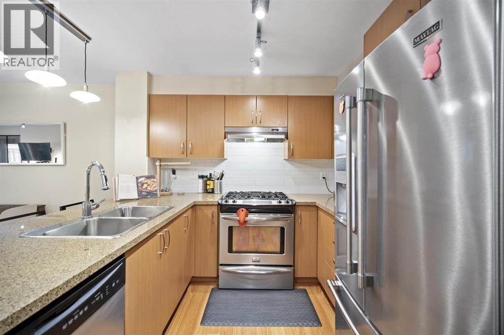 A modern kitchen with wooden cabinets and stainless steel appliances.