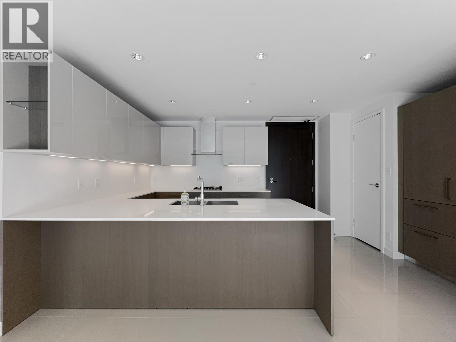 A modern kitchen with a sink and cabinets.