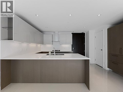 A modern kitchen with a sink and cabinets.