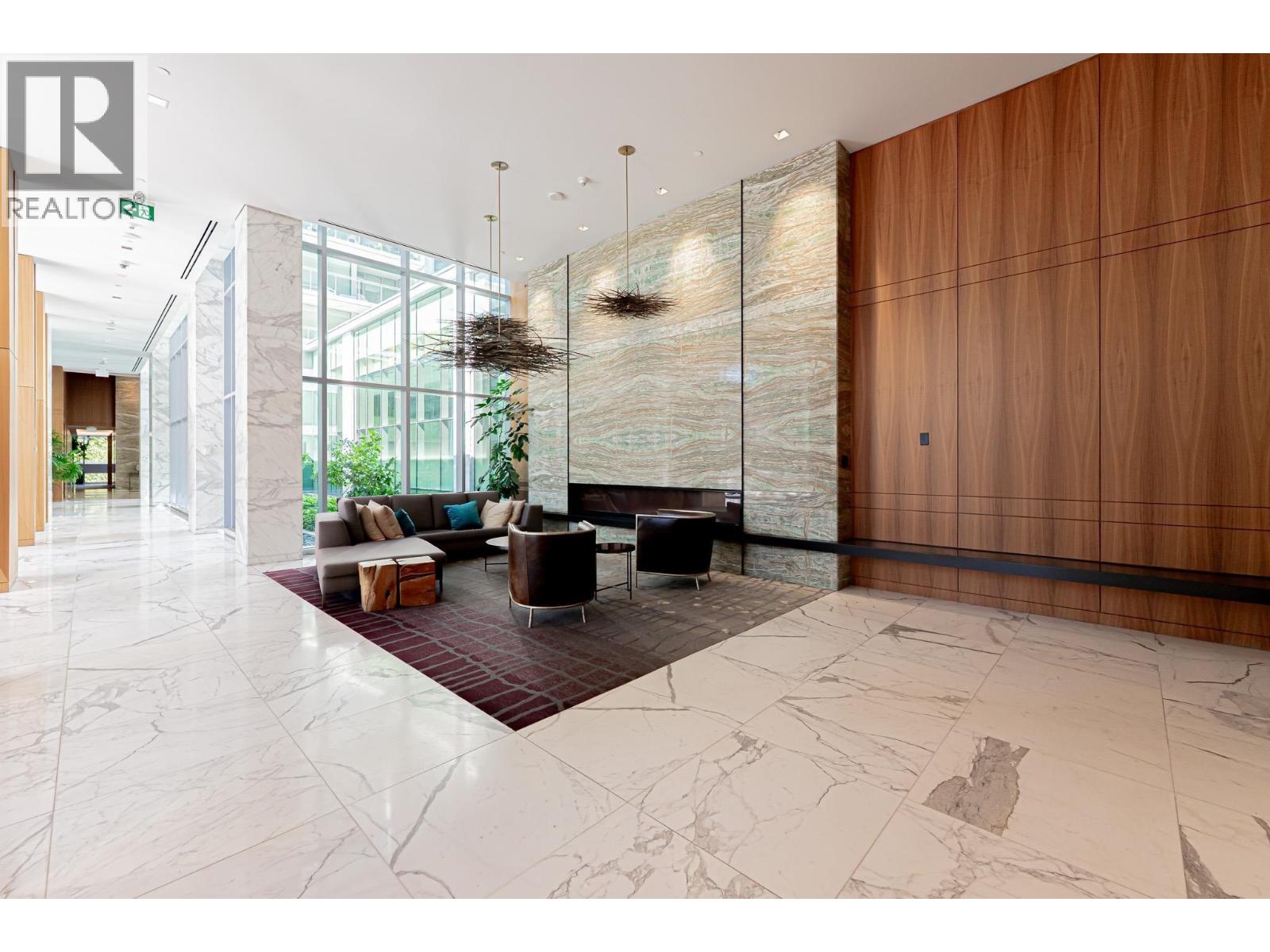 A modern living room with a glass wall and a wooden door.