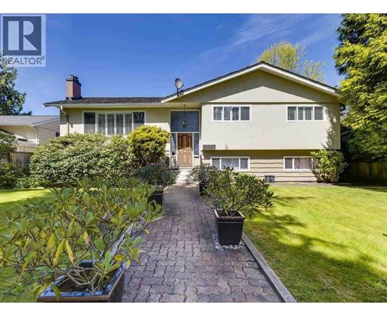 A house with a brick pathway leading to the front door.