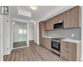 A kitchen with wooden cabinets and a stainless steel oven.