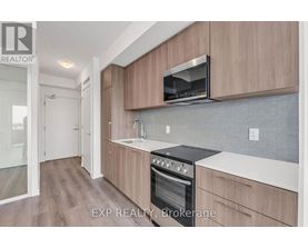 A kitchen with wooden cabinets and a black stove top oven.