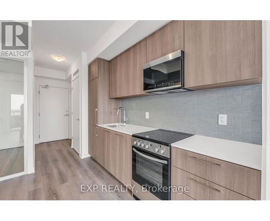 A kitchen with wooden cabinets and a black stove top oven.