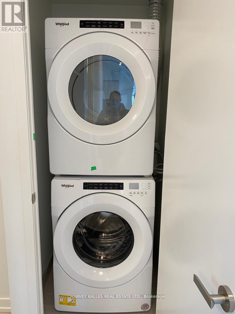 A white Whirlpool washing machine is stacked on top of another white Whirlpool washing machine.