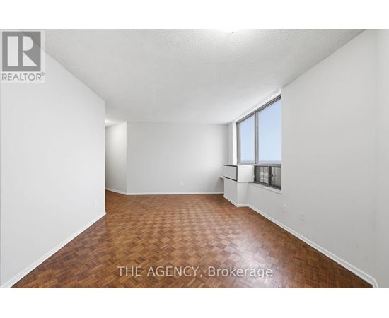 A room with a wooden floor and white walls.