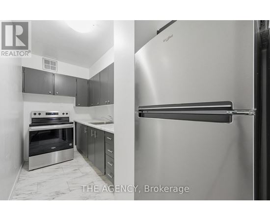 A kitchen with a stainless steel refrigerator and oven.