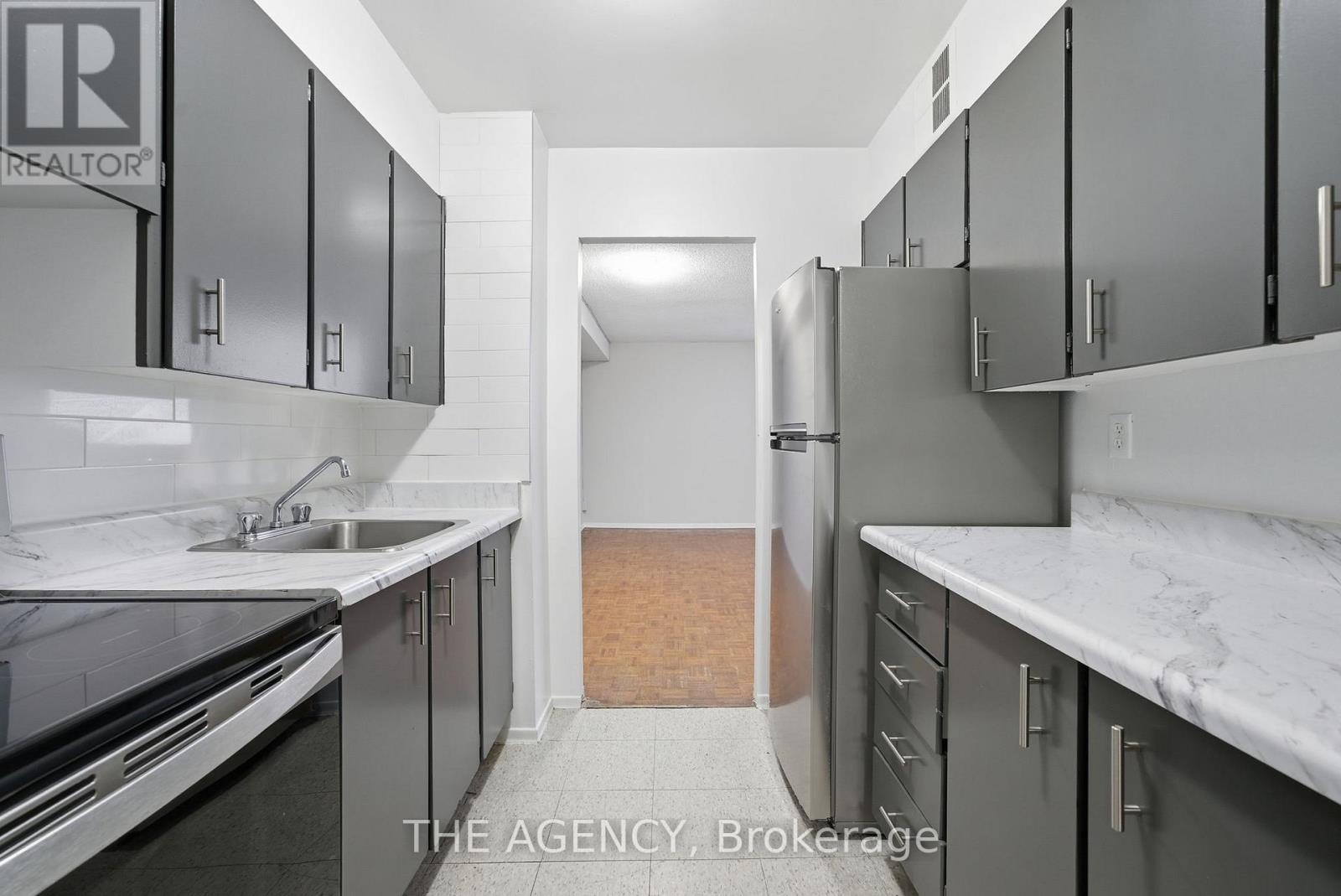 A kitchen with a sink and cabinets.