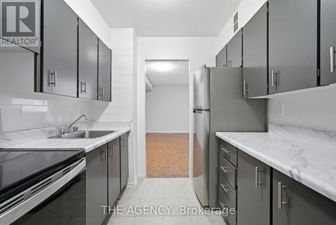 A kitchen with a sink and cabinets.