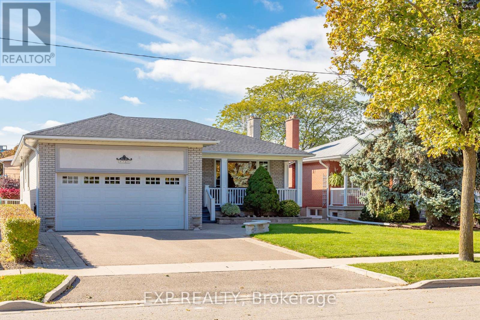 A house with a white garage door is for sale.