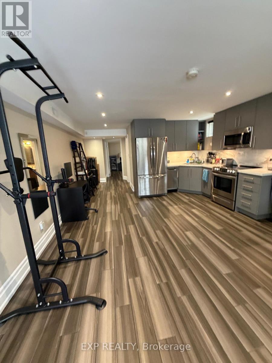A home gym with a treadmill and weights.