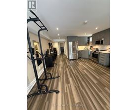 A home gym with a treadmill and weights.