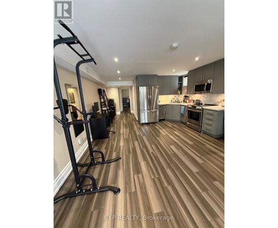 A home gym with a treadmill and weights.