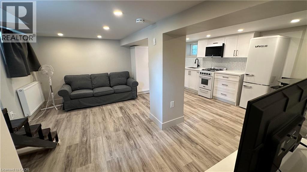 A living room with a grey couch and a television.