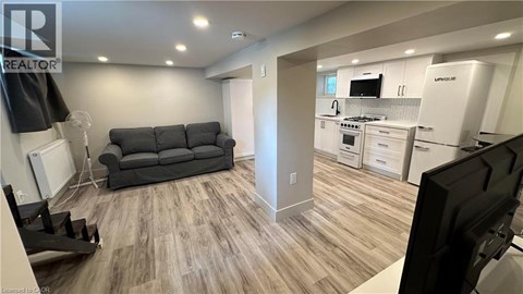 A living room with a grey couch and a television.