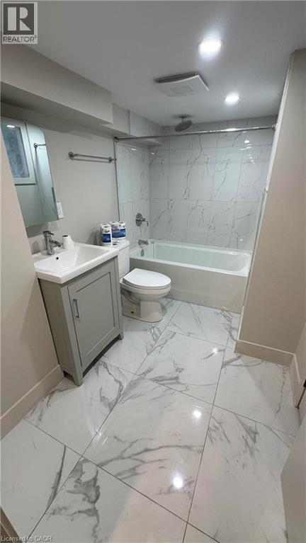 A bathroom with a marble floor and white walls.