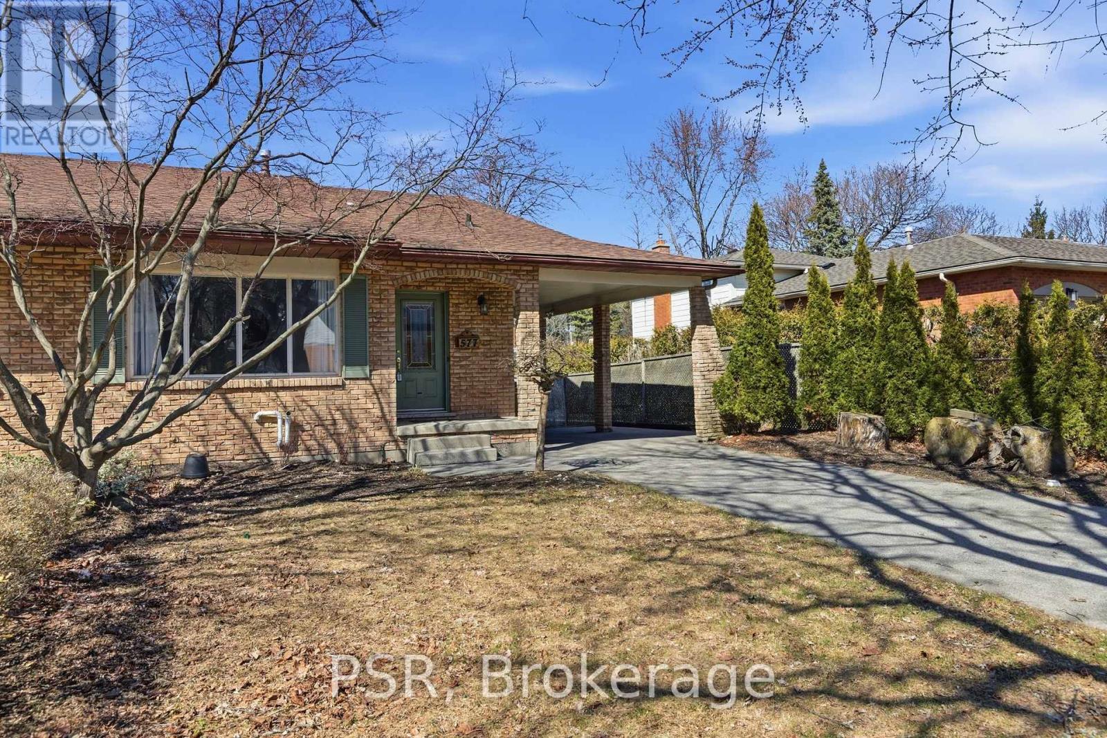 A house with a brick facade and a covered patio is for sale.