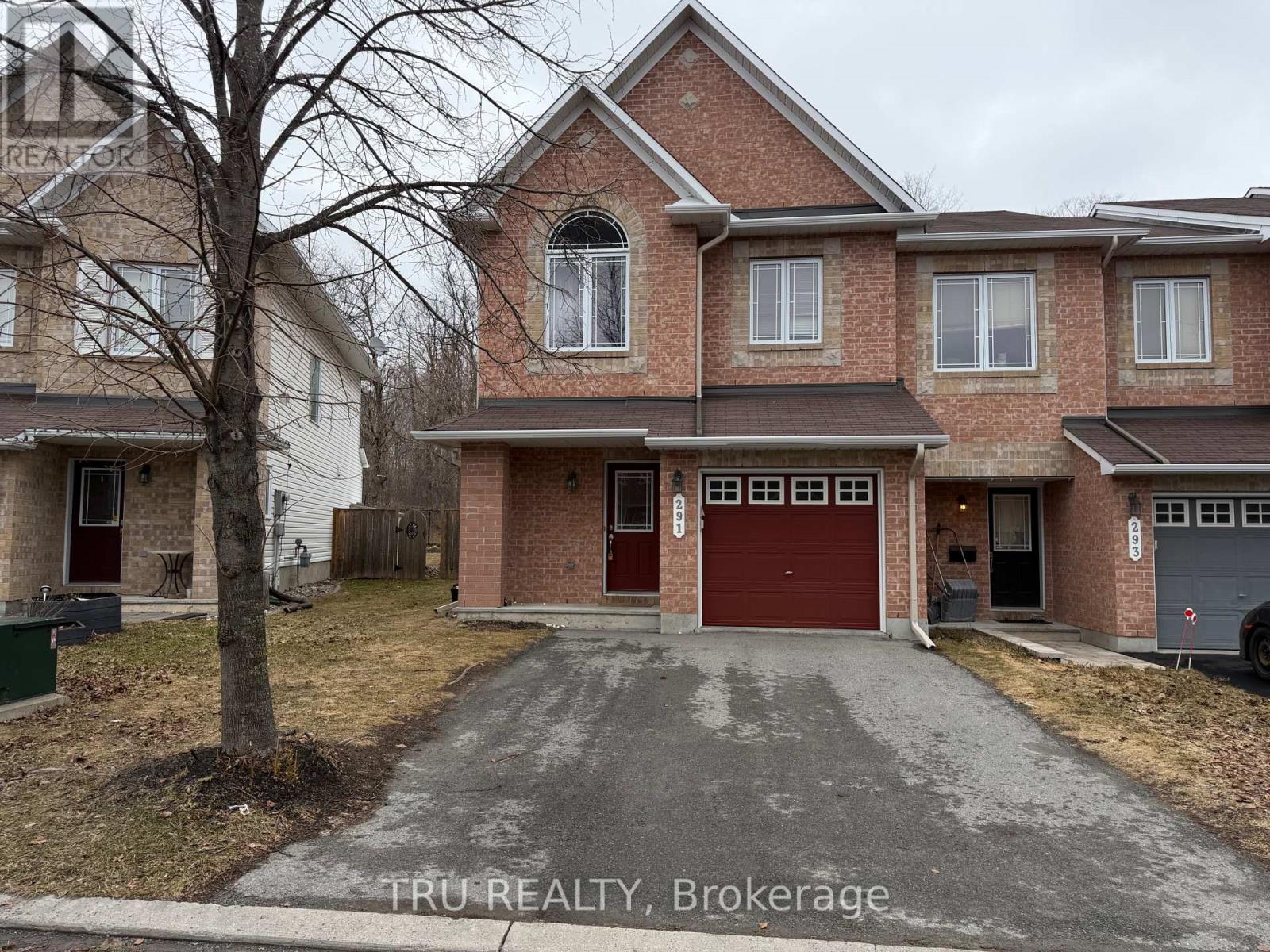 A house with a red garage door is for sale.