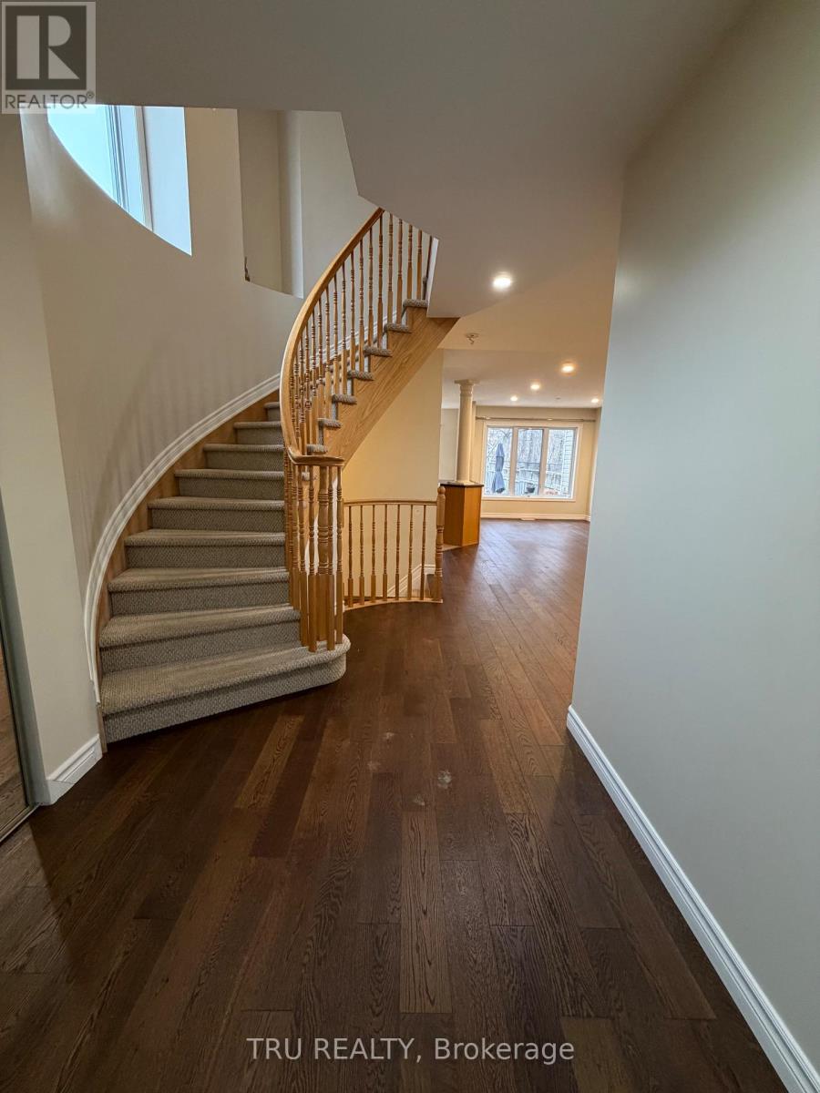 A wooden staircase with a metal railing in a house.