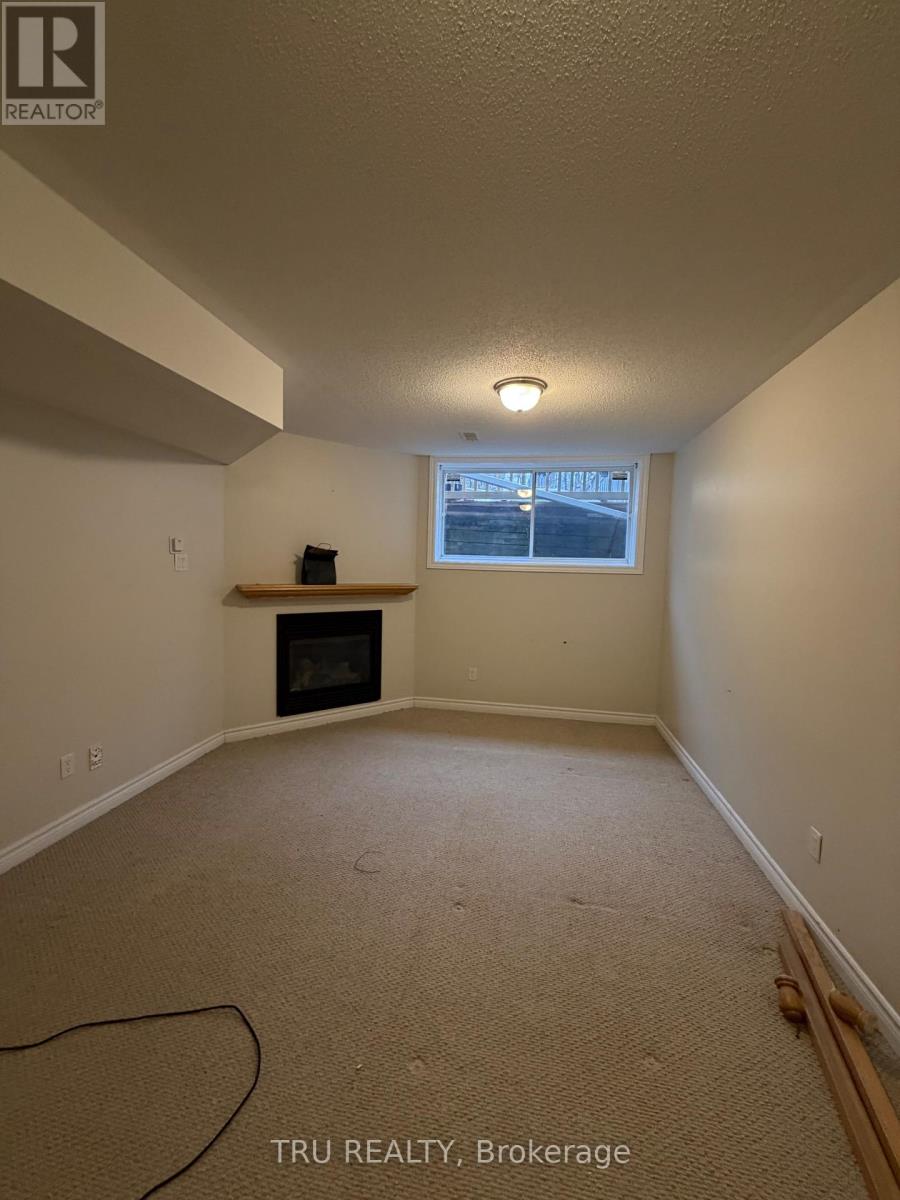 A room with a fireplace and a window.