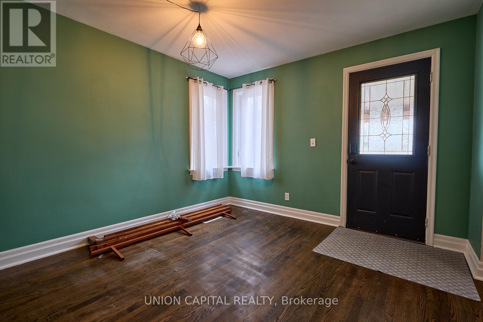 A room with green walls and a black door.