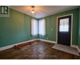 A room with green walls and a black door.